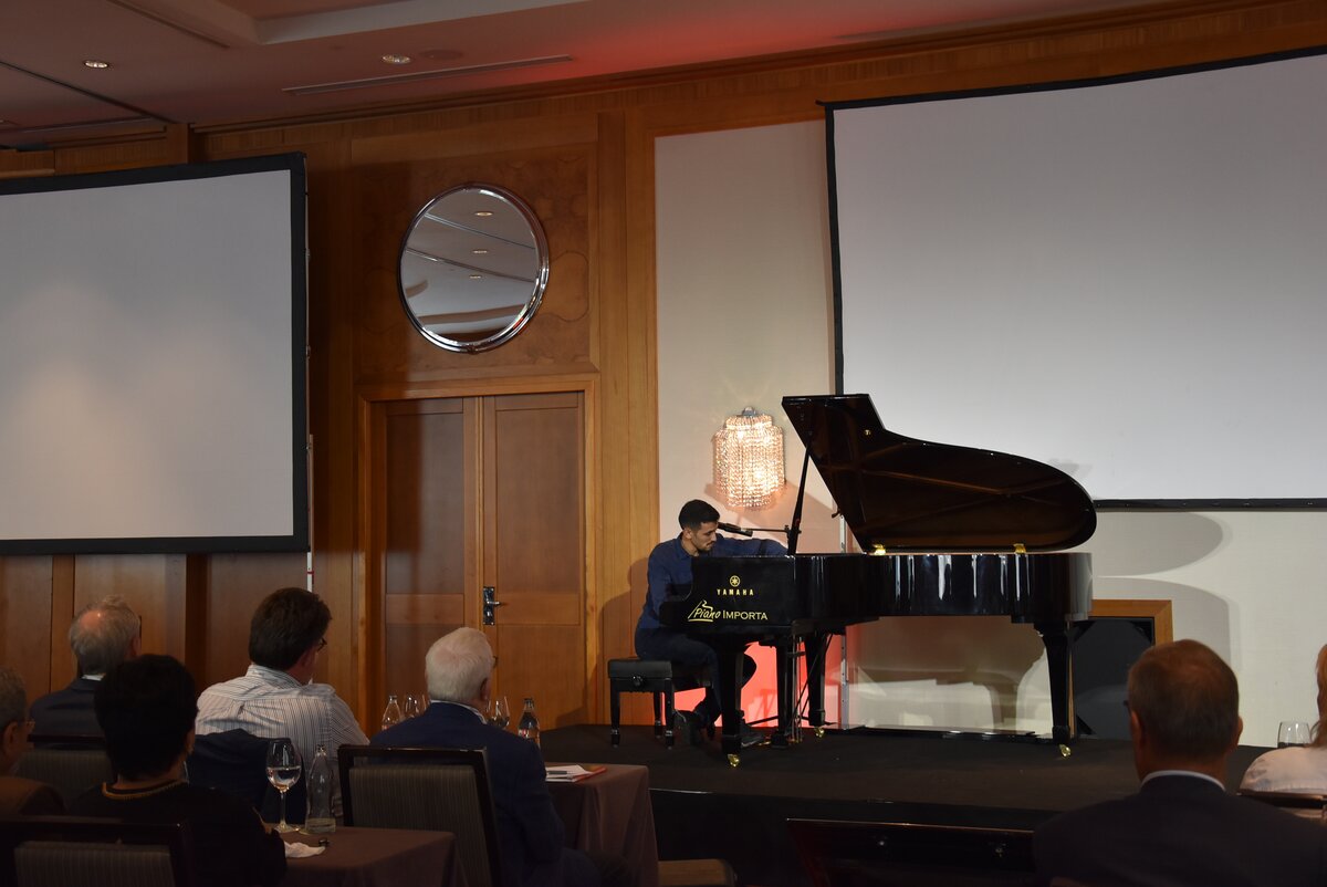 man playing piano on stage